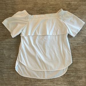 White cotton off the shoulder blouse. Longer hem in back. Elasticized shoulders